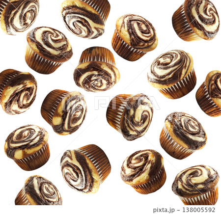 Delicious chocolate marble muffins in scattered layout, isolated on white background. Concept of sweet bakery treats 138005592