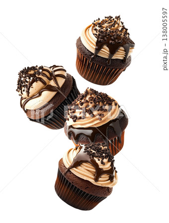 Chocolate cupcakes topped with creamy frosting, chocolate drizzle, and sprinkles on white background. Dessert and bakery concept Chocolate cupcakes topped with creamy frosting, chocolate drizzle, and sprinkles on white background. Dessert and bakery concept 138005597