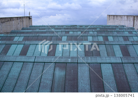 Close-up view of the rooftop of building with the blue sky and clouds. Building exterior. 138005741