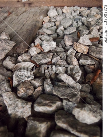 Extreme close-up view of the rocks on the old railway. Different shape of rocks on the railway. Full of rocks. Rock/stone background. Extreme close-up view of the rocks on the old railway. Different shape of rocks on the railway. Full of rocks. Rock/stone background. 138005878