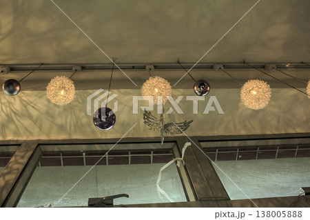 Decorative lamps hanging on the ceiling with the shadow on the wall. Interiors decoration. 138005888