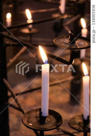 Close-up of the flame of candle in the dark in church with bokeh background. Candle light with copy space. 138005936