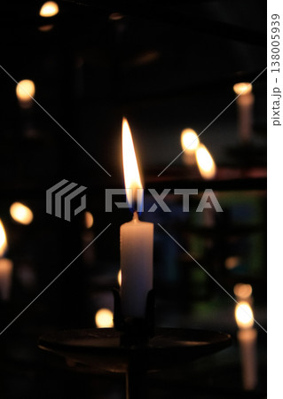 Close-up of the flame of candle in the dark in church with bokeh background. Candle light with copy space. 138005939