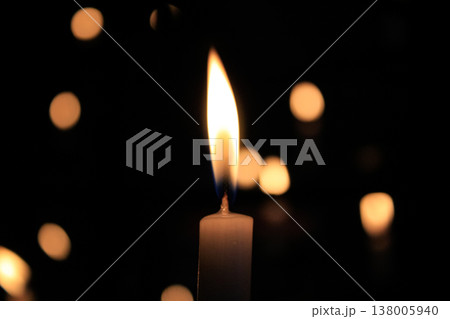 Close-up of the flame of candle in the dark in church with bokeh background. Candle light with copy space. 138005940