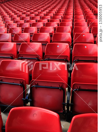 Close-up of the empty red seats in football stadium. Sport background pattern photo. Close-up of the empty red seats in football stadium. Sport background pattern photo. 138005953