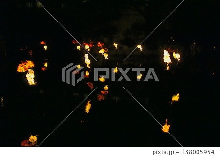 A fire show in the water, fire reflected on the water at night. A fire show in the water, fire reflected on the water at night. 138005954