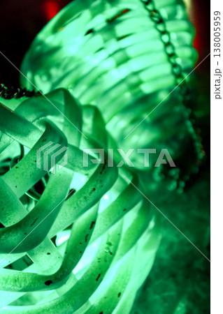 Close-up view of green glowing balls for Chinese traditional dancing performance. The performance which performs in the dark with glowing tools for depicting different shapes and movement. Close-up view of green glowing balls for Chinese traditional dancing performance. The performance which performs in the dark with glowing tools for depicting different shapes and movement. 138005959