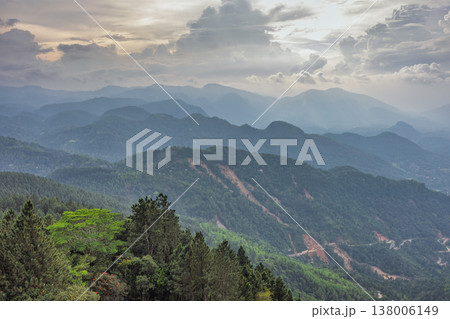 View from Ambuluwawa Tower, multi-religious temple complex located in Gampola, in Sri Lanka. Dramatic Cloudscape over Lush Green Mountain Ranges and Distant Valleys at Sunset 138006149
