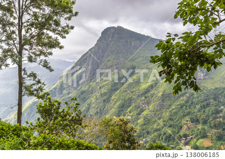 Ella rock mountain in Sri Lanka. Dramatic Mountain Landscape with Lush Greenery and Overcast Sky, Serene Highland Vista, Nature's Grandeur Ella rock mountain in Sri Lanka. Dramatic Mountain Landscape with Lush Greenery and Overcast Sky, Serene Highland Vista, Nature's Grandeur 138006185