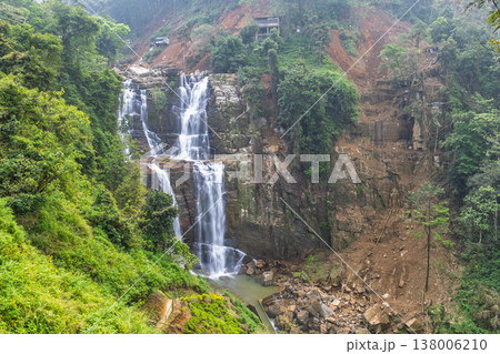 Ramboda Waterfall near Nuwara Eliya town in Sri Lanka. Majestic multi-tiered waterfall cascading down a lush vibrant green and brown hillside in a natural landscape Ramboda Waterfall near Nuwara Eliya town in Sri Lanka. Majestic multi-tiered waterfall cascading down a lush vibrant green and brown hillside in a natural landscape 138006210