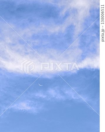 Thin Crescent Moon in Soft Blue Cloudy Sky Thin Crescent Moon in Soft Blue Cloudy Sky 138006511