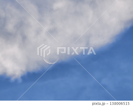 Waxing Crescent Moon Emerging from Daytime Clouds 138006515
