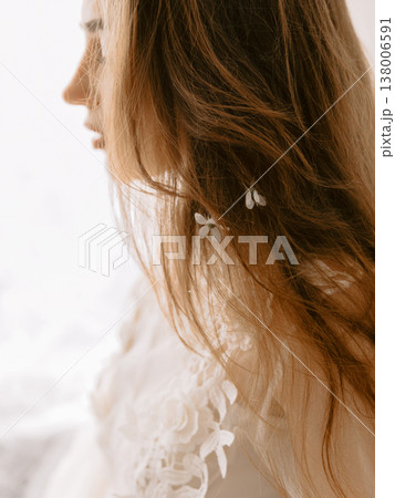 Close up of woman with natural hair and delicate flowers, romantic beauty portrait in light tones 138006591