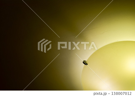Close-up of the lamp in the house in warm tone with dark background. Lighting equipment. Close-up of the lamp in the house in warm tone with dark background. Lighting equipment. 138007012