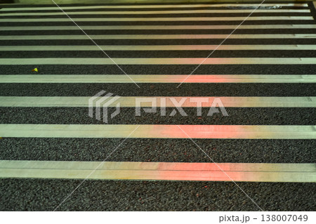 Close-up of zebra crossing at night. Cityscape, downtown scene. Close-up of zebra crossing at night. Cityscape, downtown scene. 138007049