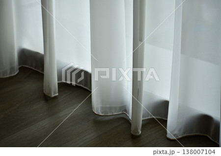 Close-up of the white curtains in the house or hotel. Sun shines through the curtain and through the window. Looking from the inside. Close-up of the white curtains in the house or hotel. Sun shines through the curtain and through the window. Looking from the inside. 138007104