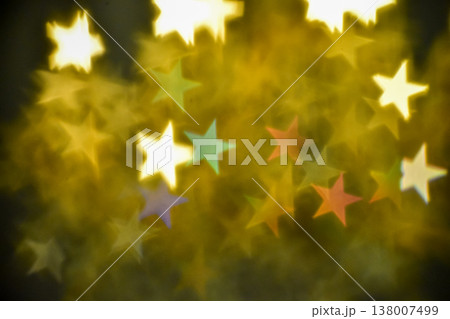 Abstract bokeh effect of the gold, yellow classic crystal lamp with star filter effect on black background. Close-up of the lamp with star effect filter on dark background. For background use. Abstract bokeh effect of the gold, yellow classic crystal lamp with star filter effect on black background. Close-up of the lamp with star effect filter on dark background. For background use. 138007499