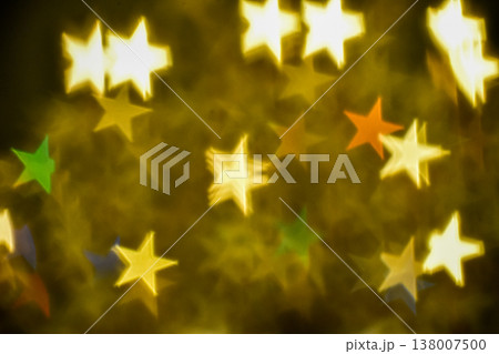 Abstract bokeh effect of the gold, yellow classic crystal lamp with star filter effect on black background. Close-up of the lamp with star effect filter on dark background. For background use. Abstract bokeh effect of the gold, yellow classic crystal lamp with star filter effect on black background. Close-up of the lamp with star effect filter on dark background. For background use. 138007500