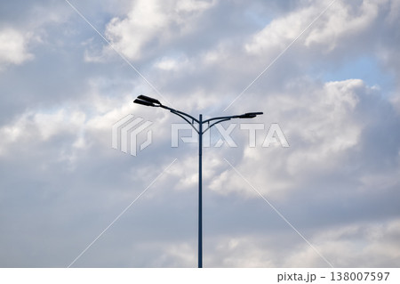 Close-up of the streetlight with blue sky background. City light in the street. Cityscape and downtown scene. Close-up of the streetlight with blue sky background. City light in the street. Cityscape and downtown scene. 138007597