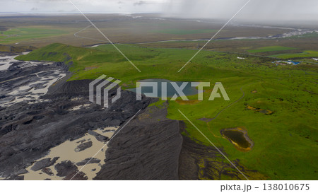 Aerial View of Iceland's Green Fields and Volcanic Terrain 138010675