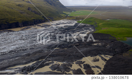 Aerial View of Icelandic Glacier, Volcanic Terrain, and Green Fields Aerial View of Icelandic Glacier, Volcanic Terrain, and Green Fields 138010678