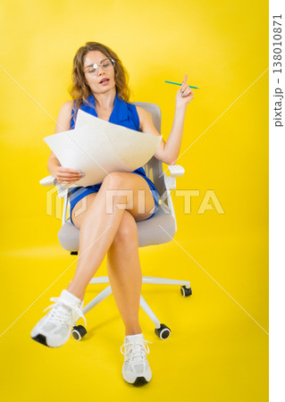 Woman generating creative ideas, holding papers and pencil Woman generating creative ideas, holding papers and pencil 138010871