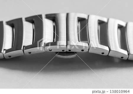 Macro shot of a brushed stainless steel watch bracelet showing interlocking links 138010964