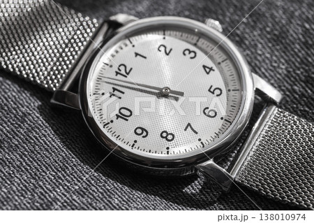 Macro shot of a modern one-hand watch in stainless steel case Macro shot of a modern one-hand watch in stainless steel case 138010974