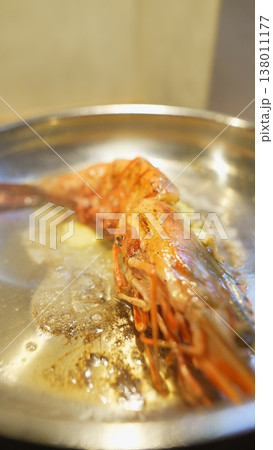 Prawn oil bubbling. Closeup of prawn shell with heat and bubbling oil Prawn oil bubbling. Closeup of prawn shell with heat and bubbling oil 138011177