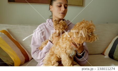 Woman attentively brushing and cleaning her domestic canine companion Woman attentively brushing and cleaning her domestic canine companion 138011274