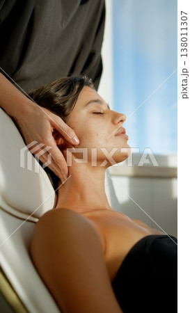 Calm neck massage session. Relaxing massage during sunset illumination 138011307