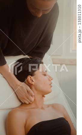 Professional delivers calming seated neck treatment session 138011310