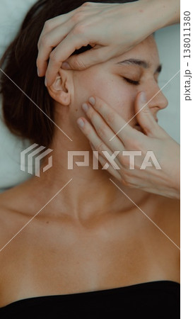 Relaxing facial therapy involves soothing gesture and skin renewal 138011380
