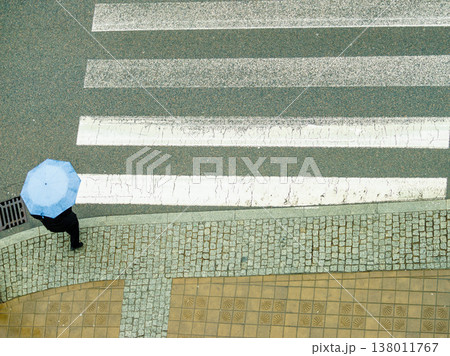 Person holding umbrella on street. 138011767