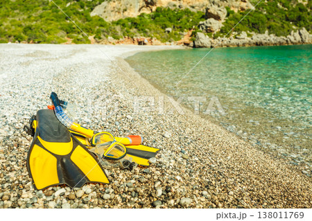 Flippers and snorkeling tube on sea shore Flippers and snorkeling tube on sea shore 138011769