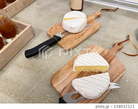Soft cheese brie or camembert on wooden board with knife kitchen serving 138012121