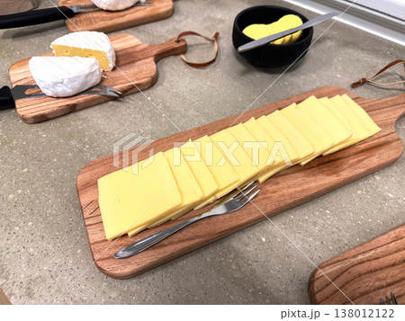 Sliced hard cheese on wooden board ready for serving food concept Sliced hard cheese on wooden board ready for serving food concept 138012122
