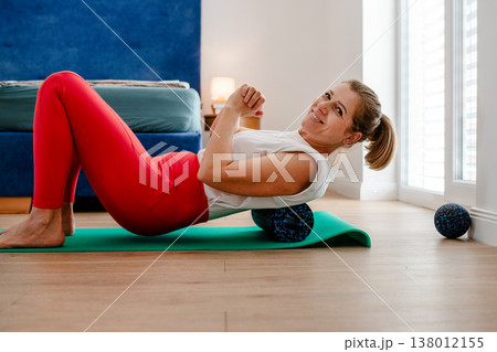 Top view of middle aged woman exercising at home. Top view of middle aged woman exercising at home. 138012155