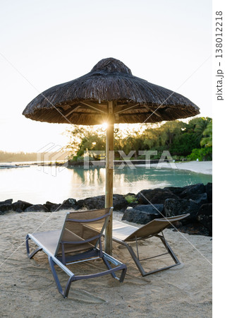 Empty sunbeds and umbrellas on tropical beach in Mauritius resort. 138012218