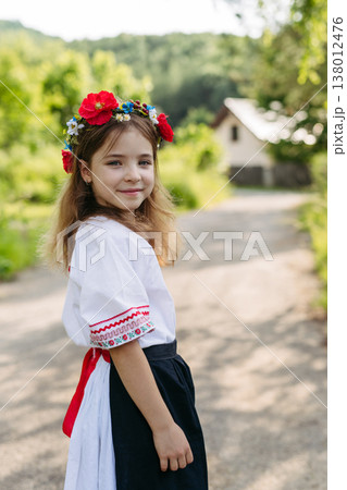 Young girl in folk costume celebrating Easter and spring traditions. Young girl in folk costume celebrating Easter and spring traditions. 138012476