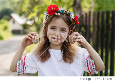 Girl holding handmade Easter eggs decorated with traditional folk techniques in Slovakia. 138012486