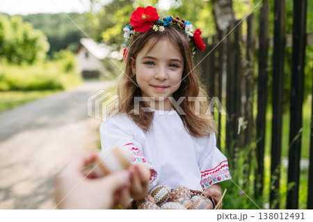 Young girl holding traditionally decorated Easter eggs with folk patterns 138012491