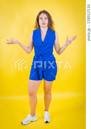 Woman shrugging her shoulders expressing confusion 138012516