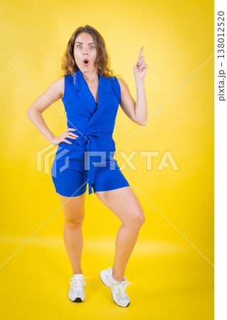 Surprised woman having an idea pointing up 138012520