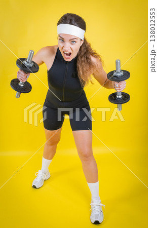 Determined woman pushing through intense fitness workout Determined woman pushing through intense fitness workout 138012553