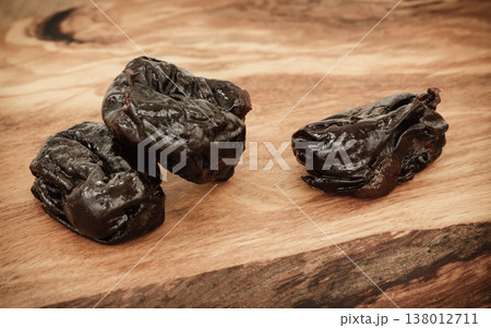dried plums prunes on wooden table dried plums prunes on wooden table 138012711