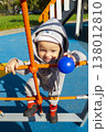 cheerful blond boy on a children's slide. boy playing on the playground. 138012810