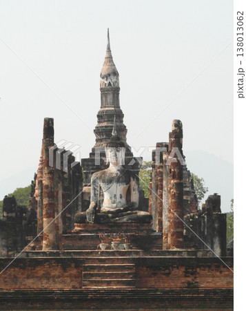 Ancient Buddha statue and ruins of Wat Mahathat in Sukhothai Historical Park Thailand 138013062