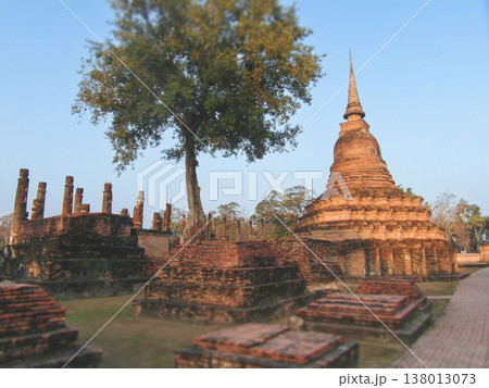 Ancient brick stupas and stone pathway at sunrise in Sukhothai Ancient brick stupas and stone pathway at sunrise in Sukhothai 138013073