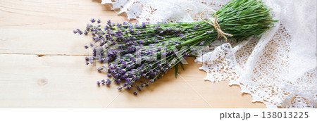 Lavender flowers lie on the table on lace 138013225